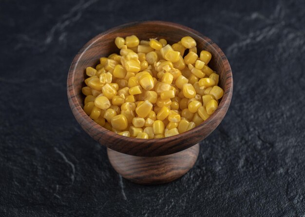 Marinated corn seeds in wooden bowl.