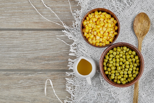 Marinated green pea beans with corns in wooden cups. 