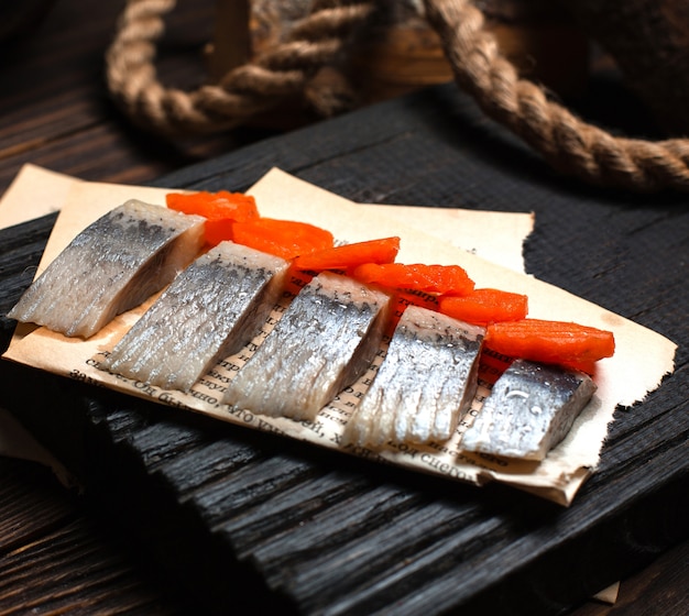 Marinated herring with fried carrots