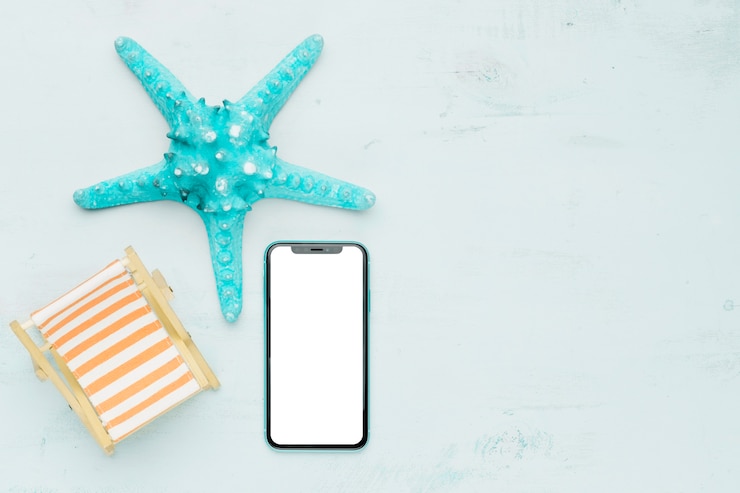 Free Photo marine composition with mobile phone on light background