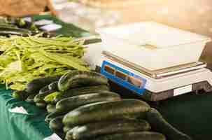 Free photo market stall with weight scale and organic vegetable on table