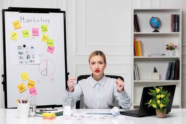 Marketing smart cute business lady in striped shirt in office angry holding fists