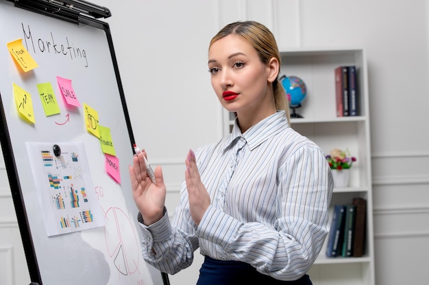 Marketing young cute business lady in striped shirt in office holding hands together explaining