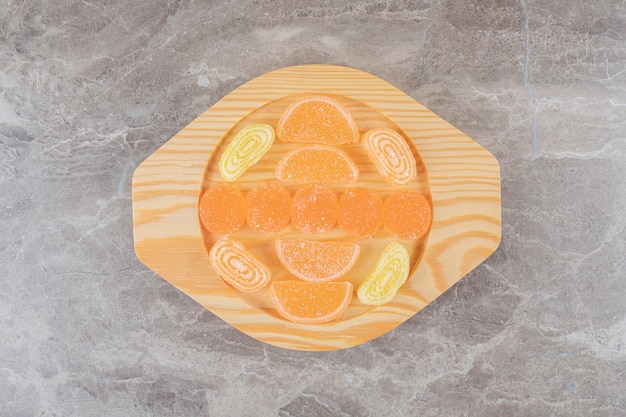 Marmelade bundle on a wooden platter on marble surface