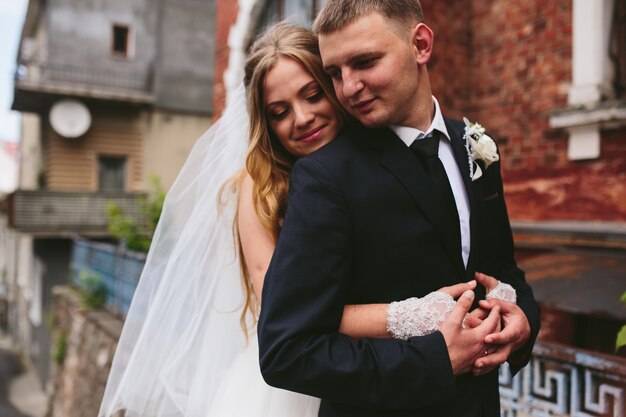 Married couple embracing in street