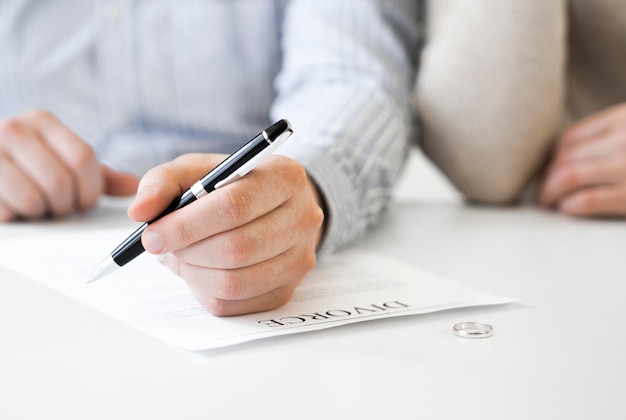 Married couple signing divorce contract