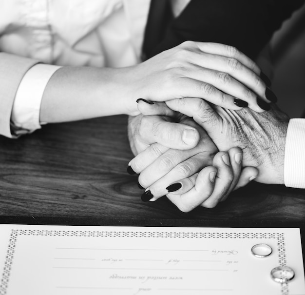 Married elderly couple with marriage certificate