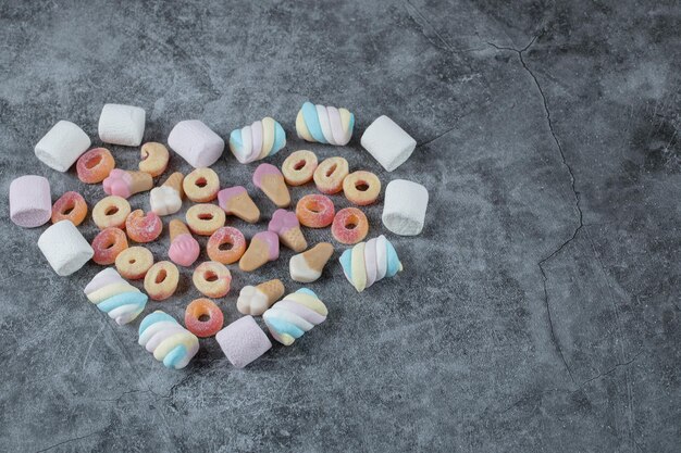 Marshmallow and jellybeans isolated on marble.