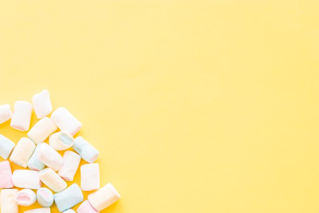 Marshmallows on the corner of the yellow background