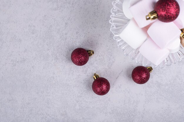 Marshmallows on glass plate with Christmas balls. High quality photo