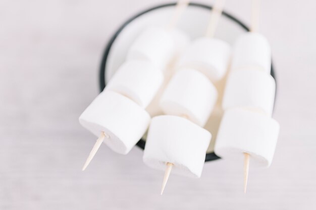 Marshmallows on sticks on cup