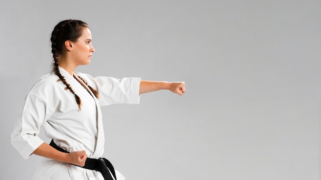 Martial arts karate girl with black belt and copy space background