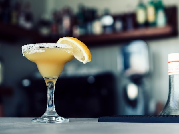 Martini glass of beverage on table