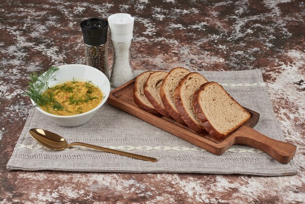 Mashed potato soup with herbs in a white bowl