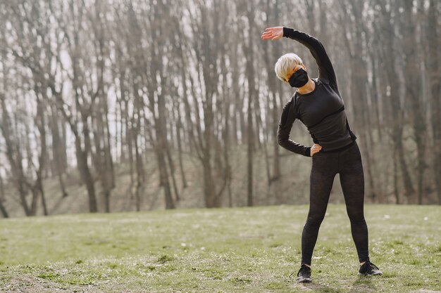 Masked woman training during coronavirus