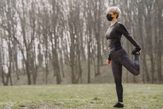 Masked woman training during coronavirus