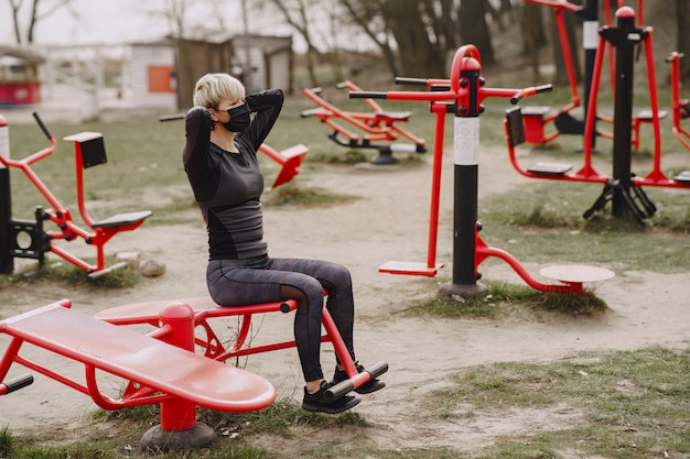 Masked woman training during coronavirus