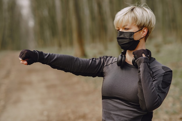 Masked woman training during coronavirus