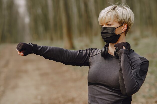 Masked woman training during coronavirus