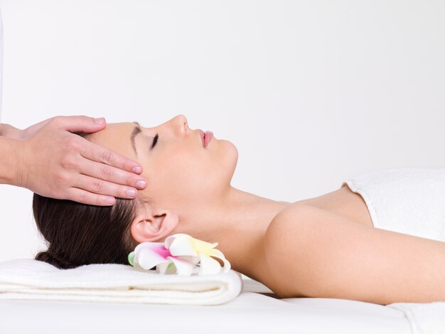 Massage for the face of young beautiful woman - horizontal