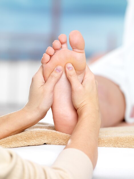 Massage on the foot in spa salon, close-up