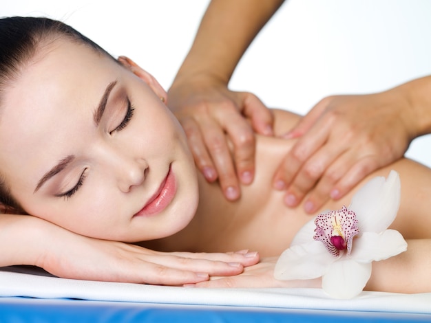 Massage on the shoulder of beautiful dirl in beauty salon - horizontal