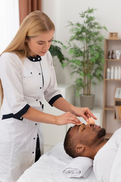 Masseur taking care of her client