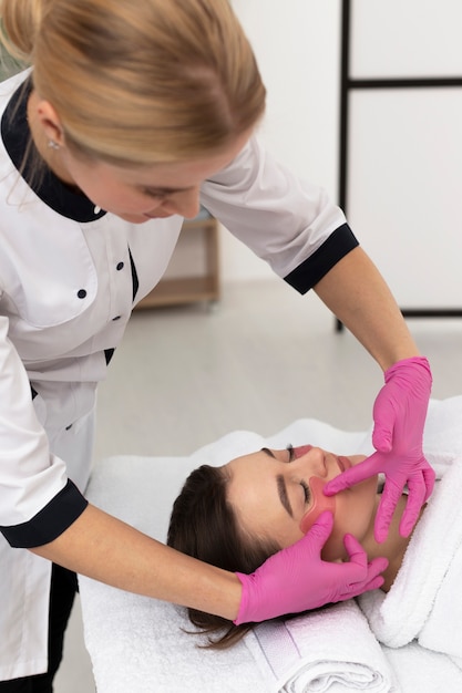 Free photo masseur taking care of her client