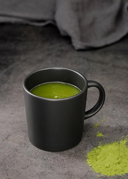 Matcha tea in cup with powder