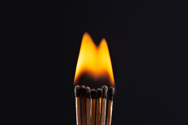 Matches burning with dark background