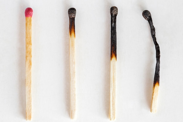 Matches, one whole and three burnt, macro close-up