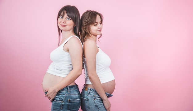 maternity concept, two pregnant women with an open tummy