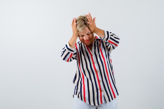 Free photo mature blonde woman in a vertical-striped shirt