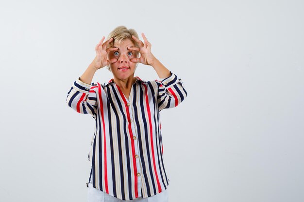 Mature blonde woman in a vertical-striped shirt