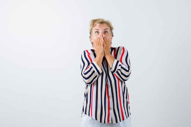 Mature blonde woman in a vertical-striped shirt