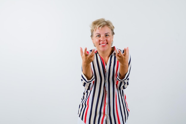 Free photo mature blonde woman in a vertical-striped shirt