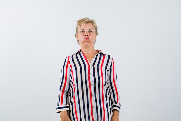 Free photo mature blonde woman in a vertical-striped shirt