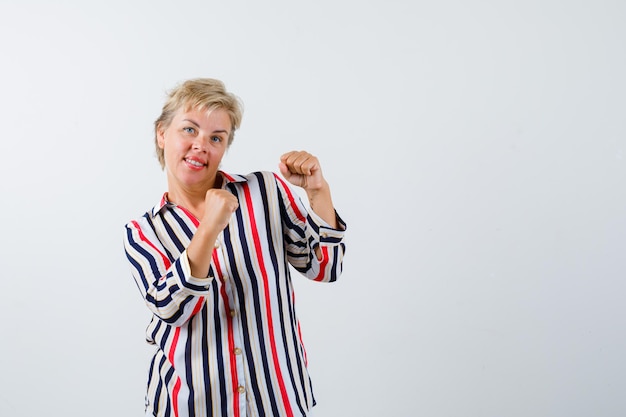 Mature blonde woman in a vertical-striped shirt