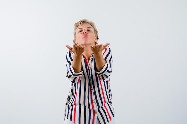 Mature blonde woman in a vertical-striped shirt