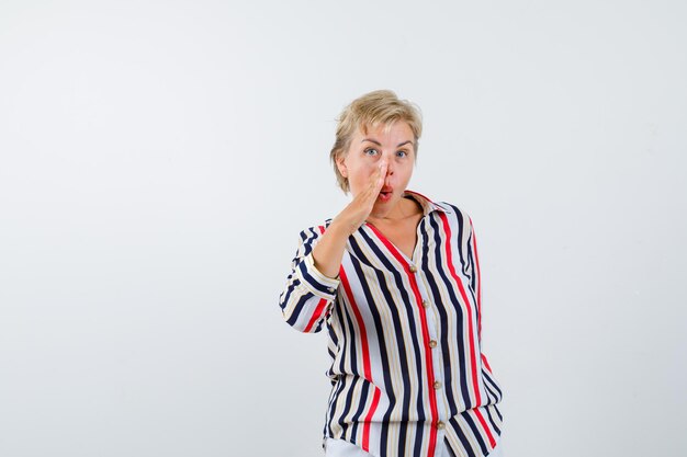 Mature blonde woman in a vertical-striped shirt