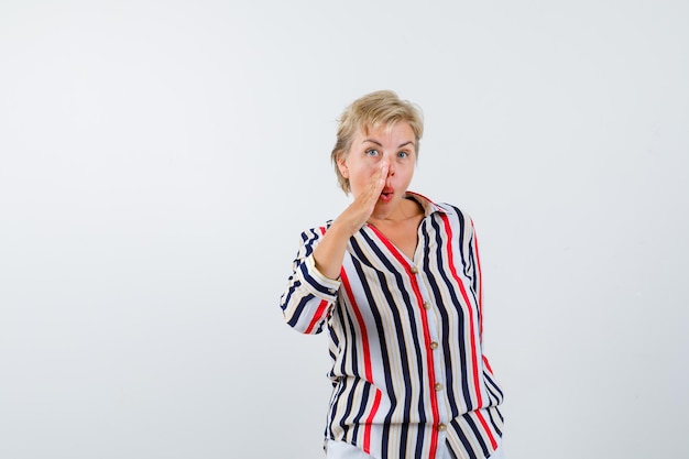 Mature blonde woman in a vertical-striped shirt