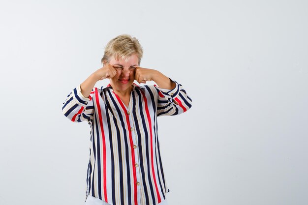 Mature blonde woman in a vertical-striped shirt