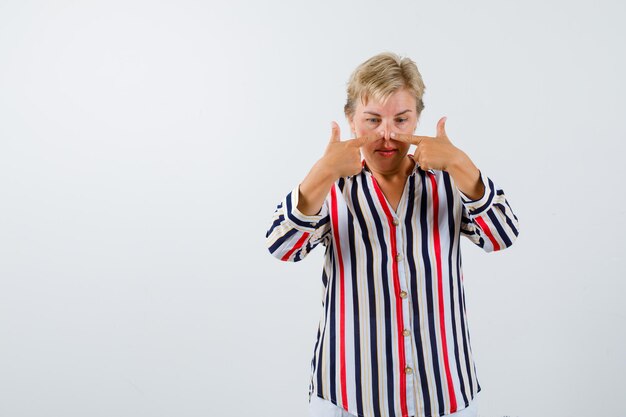 Mature blonde woman in a vertical-striped shirt