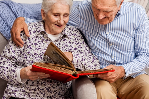 Mature couple looking into photo album