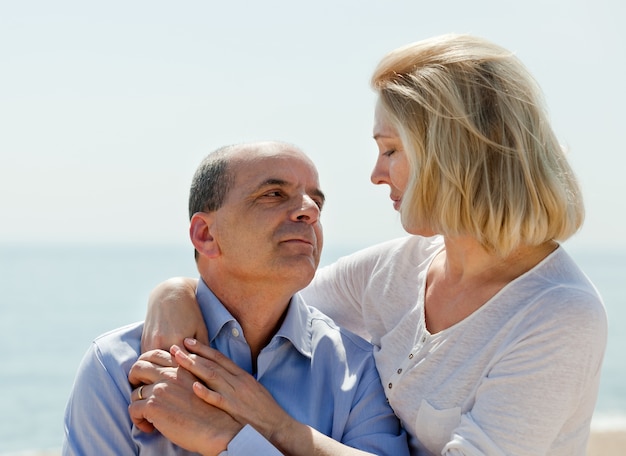 Mature couple together at sea