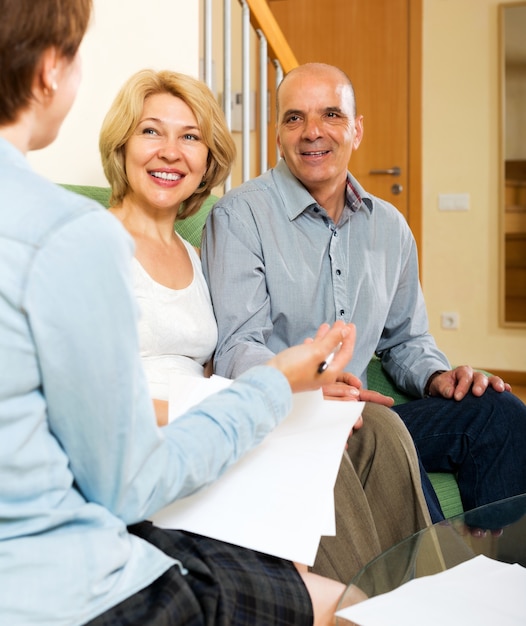 Mature couple with insurance agent