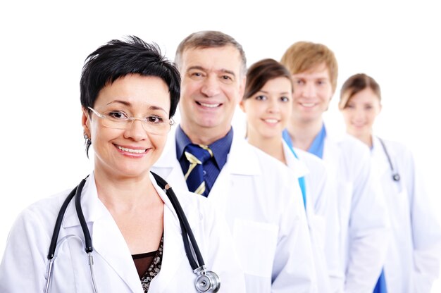Mature female doctor with group of happy successsful colleagues
