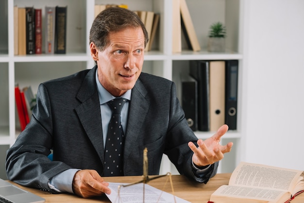 Mature lawyer having conversation in the court room