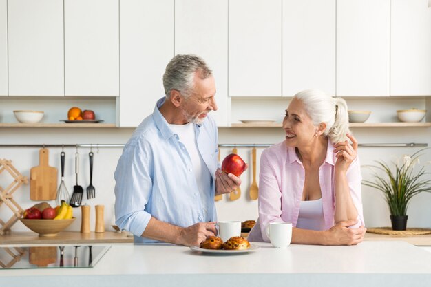 Mature loving couple family standing at the kitchen