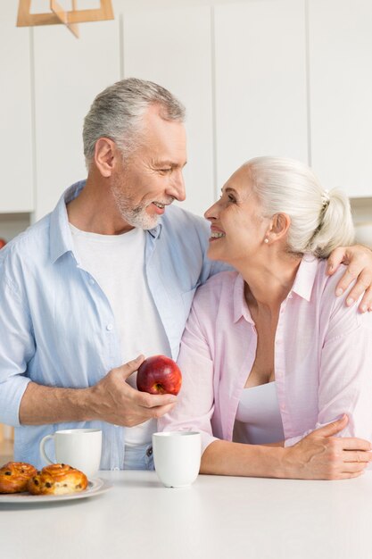 Mature loving couple family standing at the kitchen